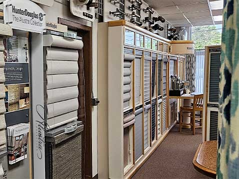 Store interior showcasing several different types of window coverings